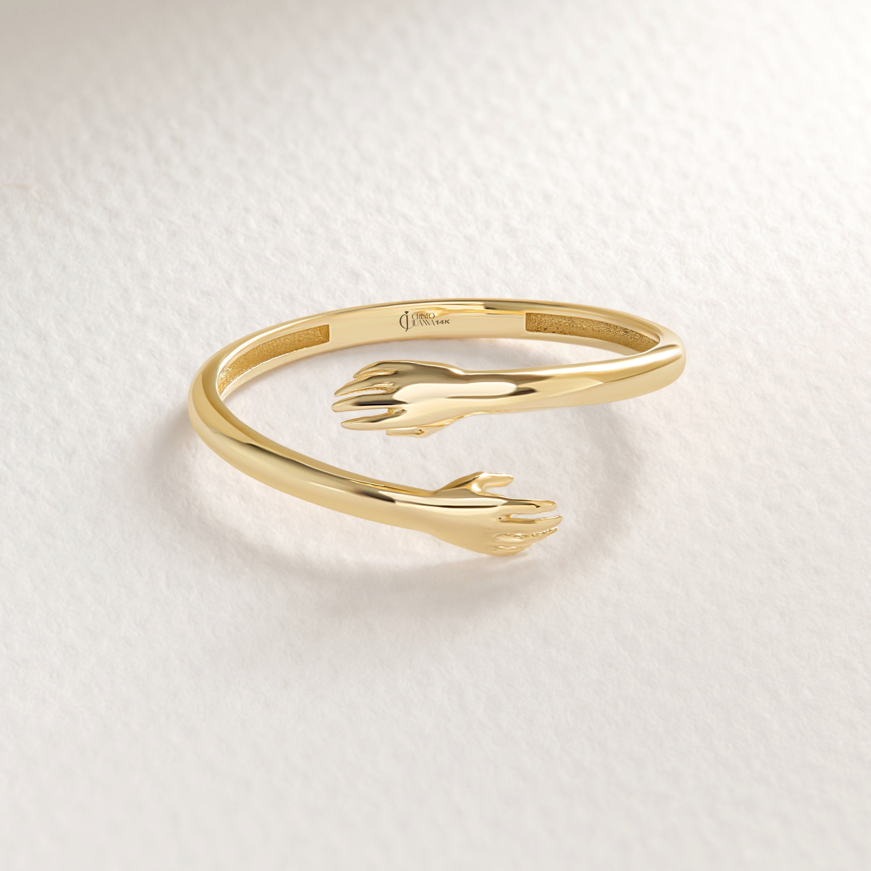 A gold ring that symbolizes a constant embrace for the one you gift it to. Available in various gold purities, it's an elegant and meaningful choice for any occasion.