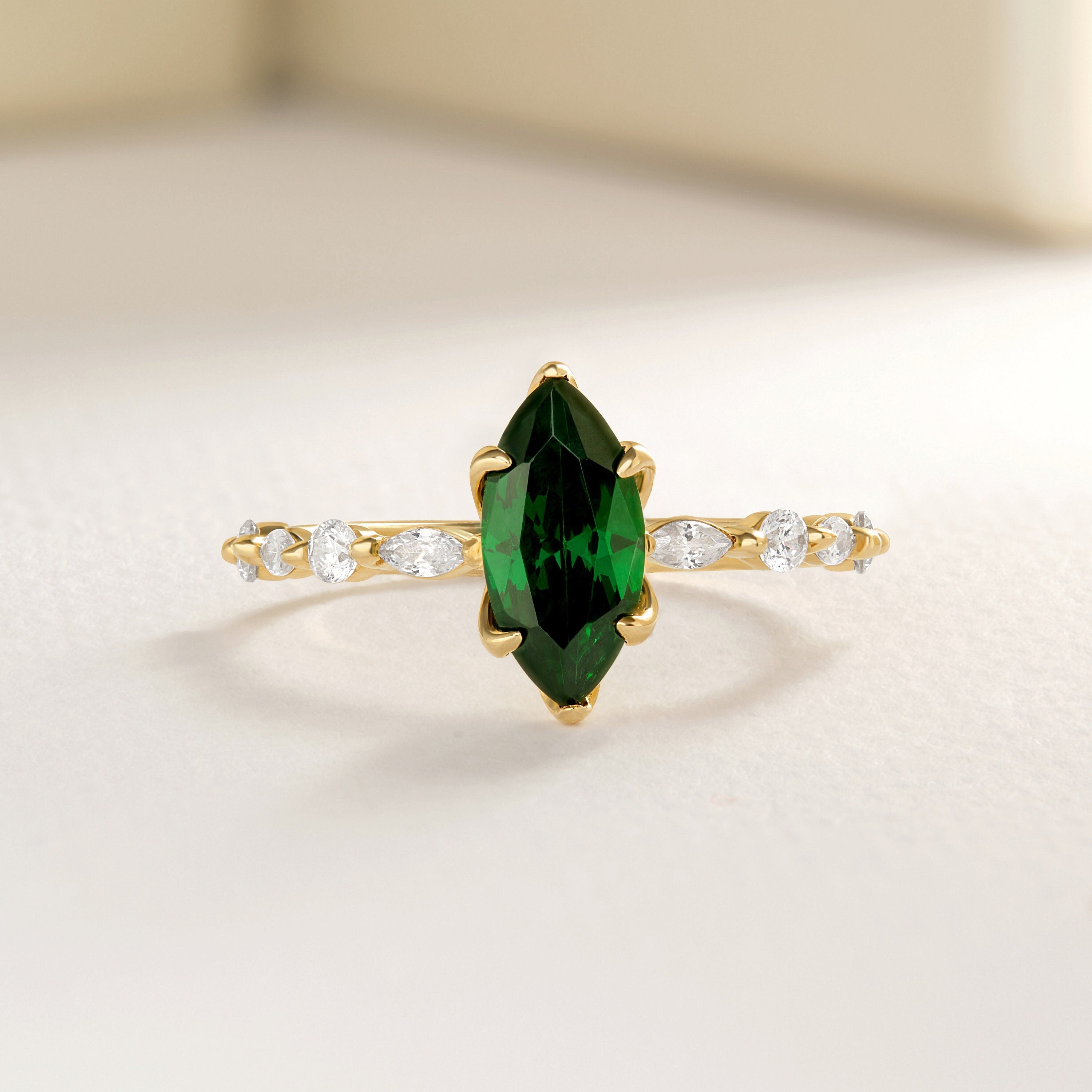 ๐ Marquise Emerald Engagement Ring โ 14K Solid Gold Side Diamond Band ๐
Make her heart sparkle with this marquise-cut emerald engagement ring, featuring a vivid green gemstone at its center and dazzling round-cut side diamonds for extra brilliance. This piece combines timeless elegance with a touch of modern artistry โ perfect for engagements, anniversaries, or meaningful gifts.