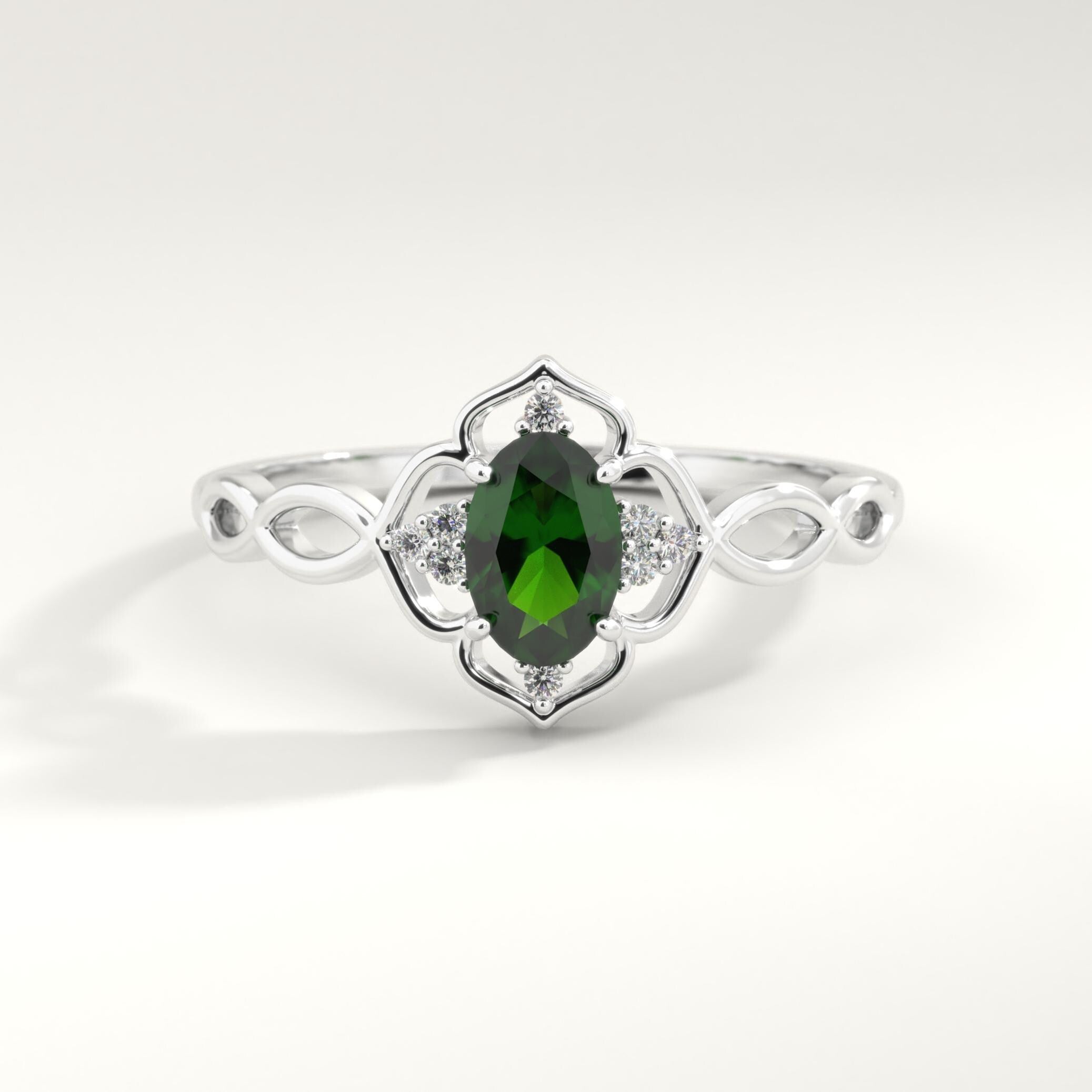 Oval Emerald Engagement Ring – 14K Solid Gold Lace Infinity Band 💚✨
A romantic fusion of elegance and vintage artistry — this oval emerald engagement ring features a vivid green center stone embraced by sparkling side diamonds along a lace-inspired infinity band. Handcrafted in solid 14K gold, its split-shank design symbolizes eternal love, balance, and connection, making it the perfect birthstone or anniversary ring.