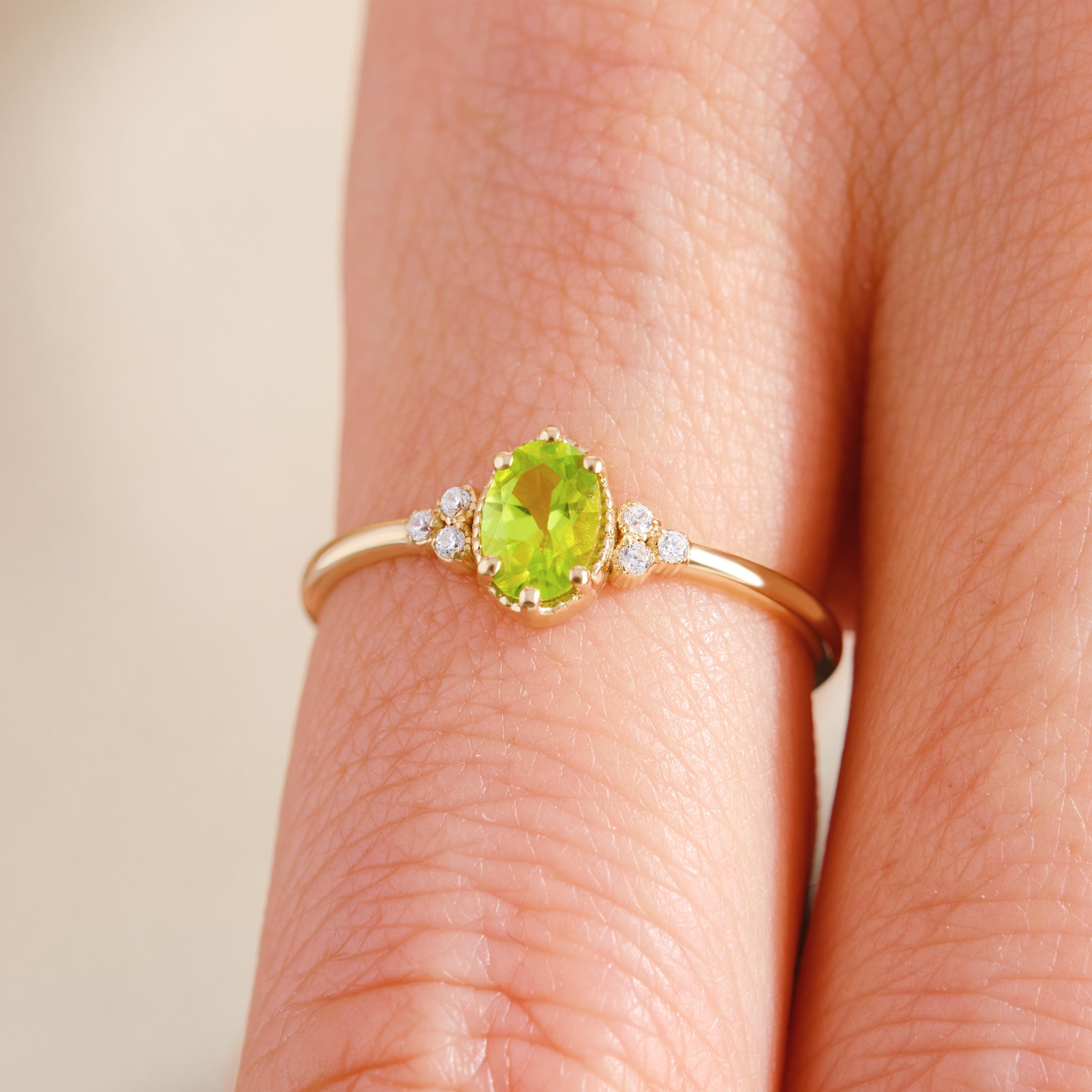 Natural Peridot Engagement Ring – 10K / 14K / 18K Solid Gold ✨💚
Celebrate love with this genuine oval-cut peridot ring, beautifully accented with sparkling side diamonds. Its fresh green glow makes it a unique engagement or wedding ring, perfect for women who adore natural beauty with a vintage touch.