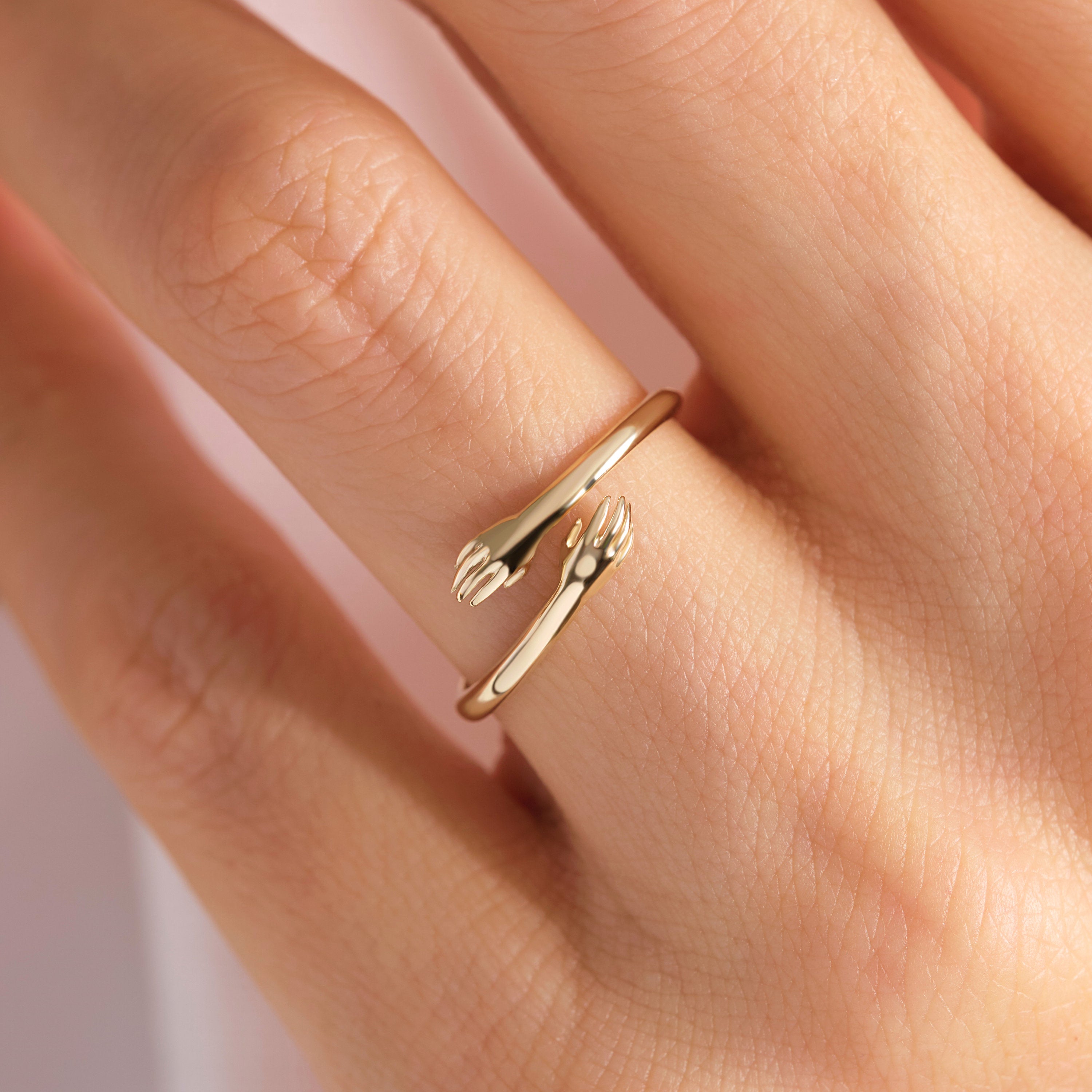 Here's the Hugging Lovingly Ring Gold by Christo! Our 10K 14K 14K Gold Hug Stacking Ring is perfect Stackable and Daily Wear Ring for Girls. This Love Hands Open Cuff Stacked Band is designed as Premium Chick Index Finger Ring