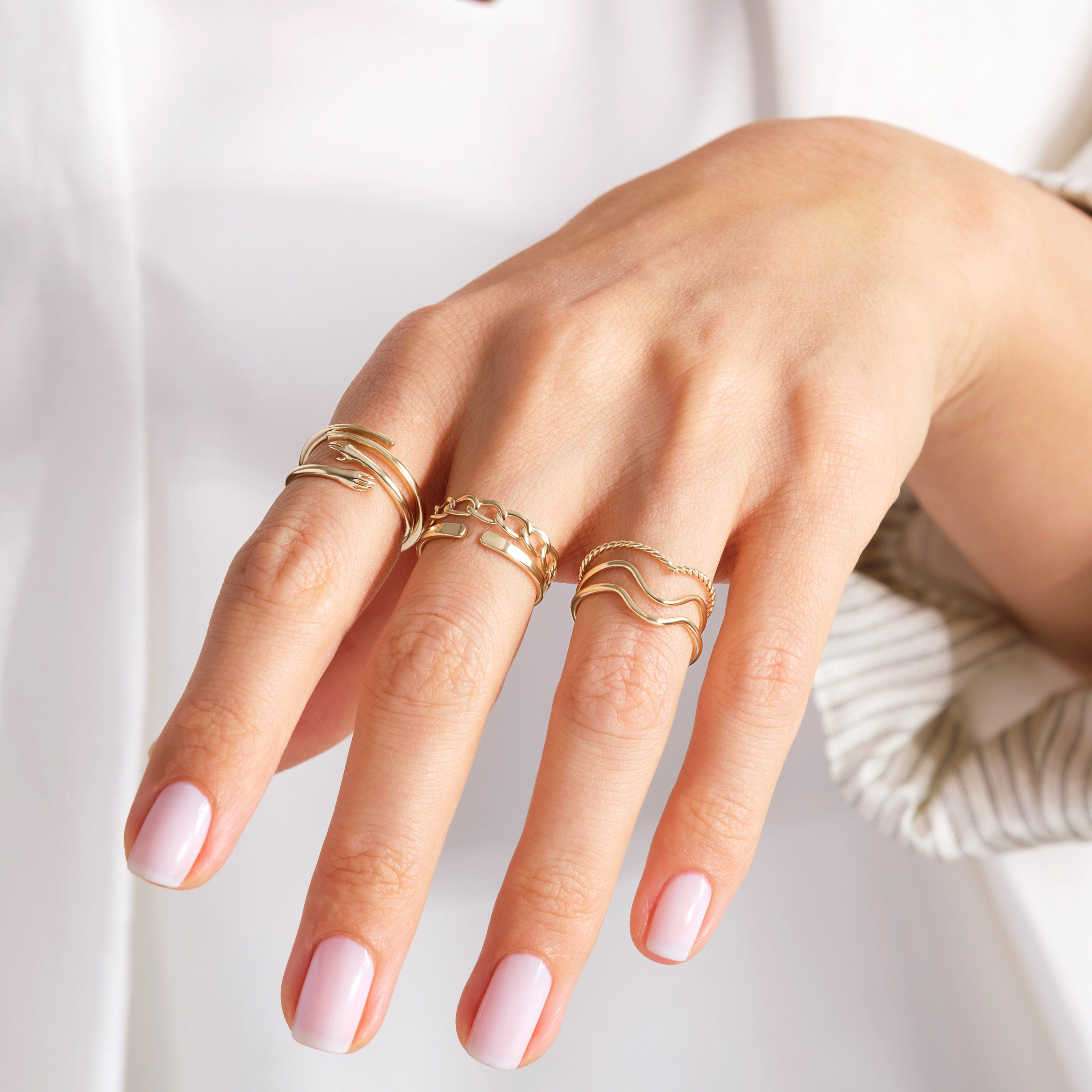 Here's the Hugging Lovingly Ring Gold by Christo! Our 10K 14K 14K Gold Hug Stacking Ring is perfect Stackable and Daily Wear Ring for Girls. This Love Hands Open Cuff Stacked Band is designed as Premium Chick Index Finger Ring