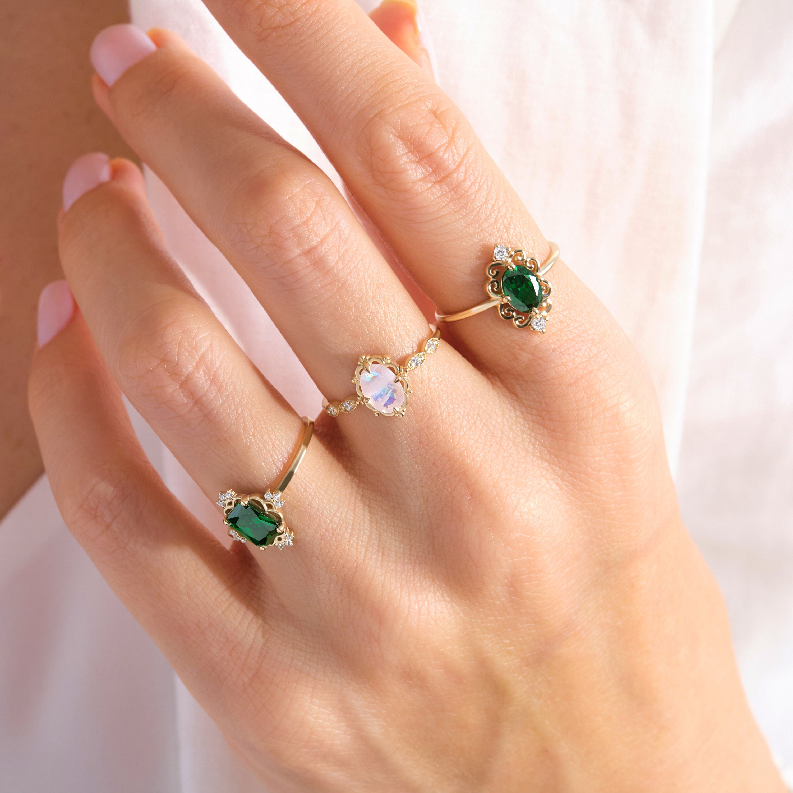 Emerald Cut Emerald Wedding Ring – 14K Solid Gold Band with Side Diamonds 💚✨
This Emerald Cut Wedding Ring celebrates timeless beauty and craftsmanship. Featuring a stunning 7x5 mm natural emerald surrounded by sparkling side diamonds, it radiates sophistication and meaning. The rectangular emerald symbolizes renewal and growth — a perfect piece for weddings, anniversaries, or milestone celebrations.