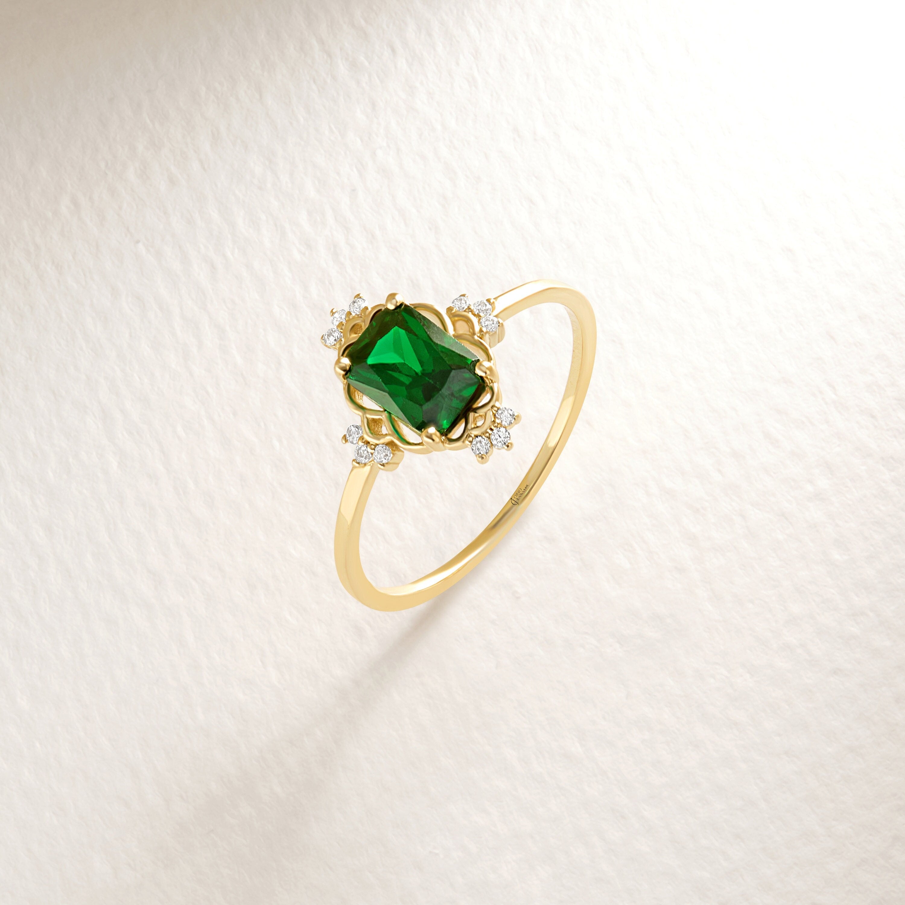 Emerald Cut Emerald Wedding Ring – 14K Solid Gold Band with Side Diamonds 💚✨
This Emerald Cut Wedding Ring celebrates timeless beauty and craftsmanship. Featuring a stunning 7x5 mm natural emerald surrounded by sparkling side diamonds, it radiates sophistication and meaning. The rectangular emerald symbolizes renewal and growth — a perfect piece for weddings, anniversaries, or milestone celebrations.