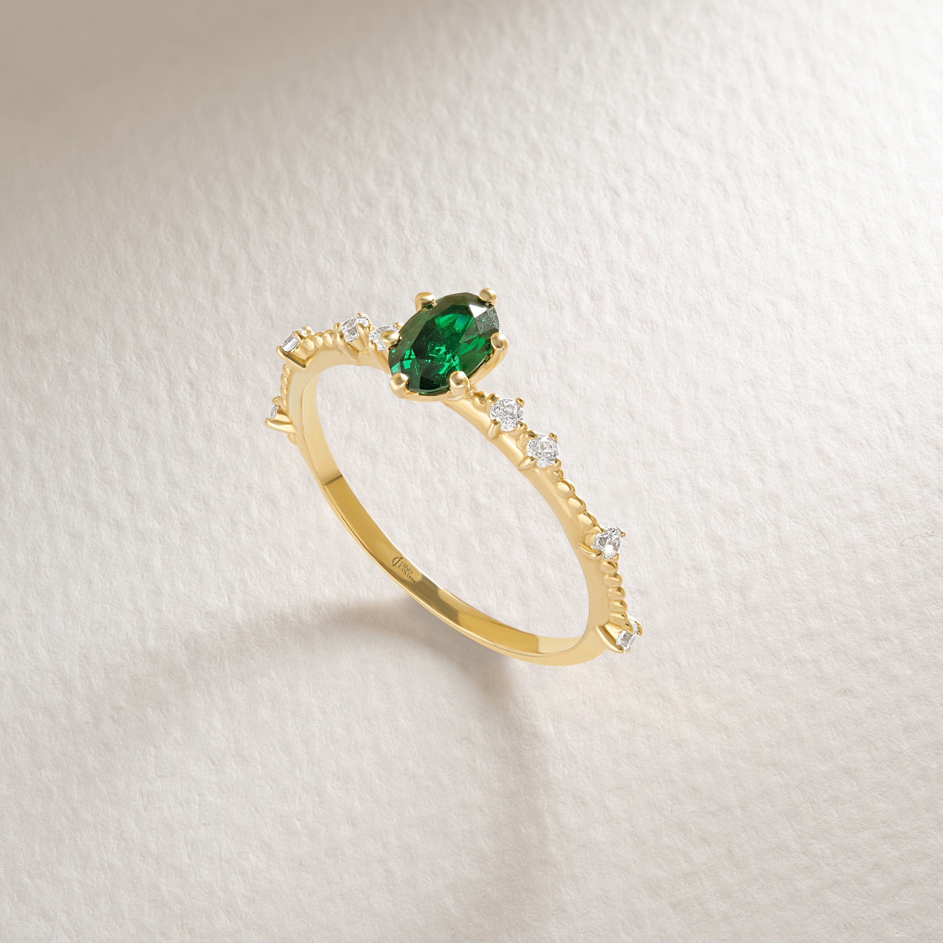 Oval Emerald Engagement Ring – 14K Solid Gold with Side Diamonds 💚✨
Elegant, timeless, and deeply symbolic — this oval emerald engagement ring celebrates love and renewal in every detail. Featuring a vivid green oval-cut emerald at its center, delicately framed by a fine row of tiny moissanite diamonds, this piece perfectly balances luxury and sentiment. Its milgrain side detailing adds a subtle vintage touch, making it an ideal ring for weddings, anniversaries, or heartfelt gifts.