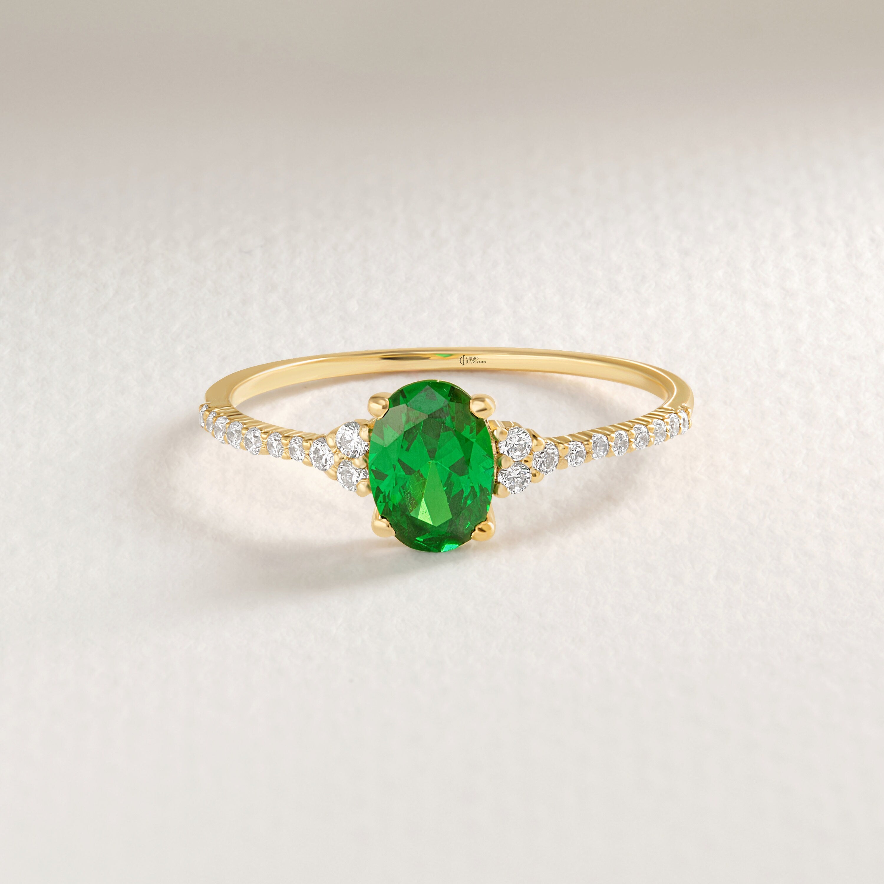 Oval Emerald Engagement Ring – 14K Solid Gold with Side Diamonds 💚✨
Refined, radiant, and meaningful — this Oval Emerald Engagement Ring brings together timeless elegance and modern sparkle. The deep green emerald at its center symbolizes love and renewal, while the shimmering side moissanites add a touch of brilliance for a truly captivating finish.