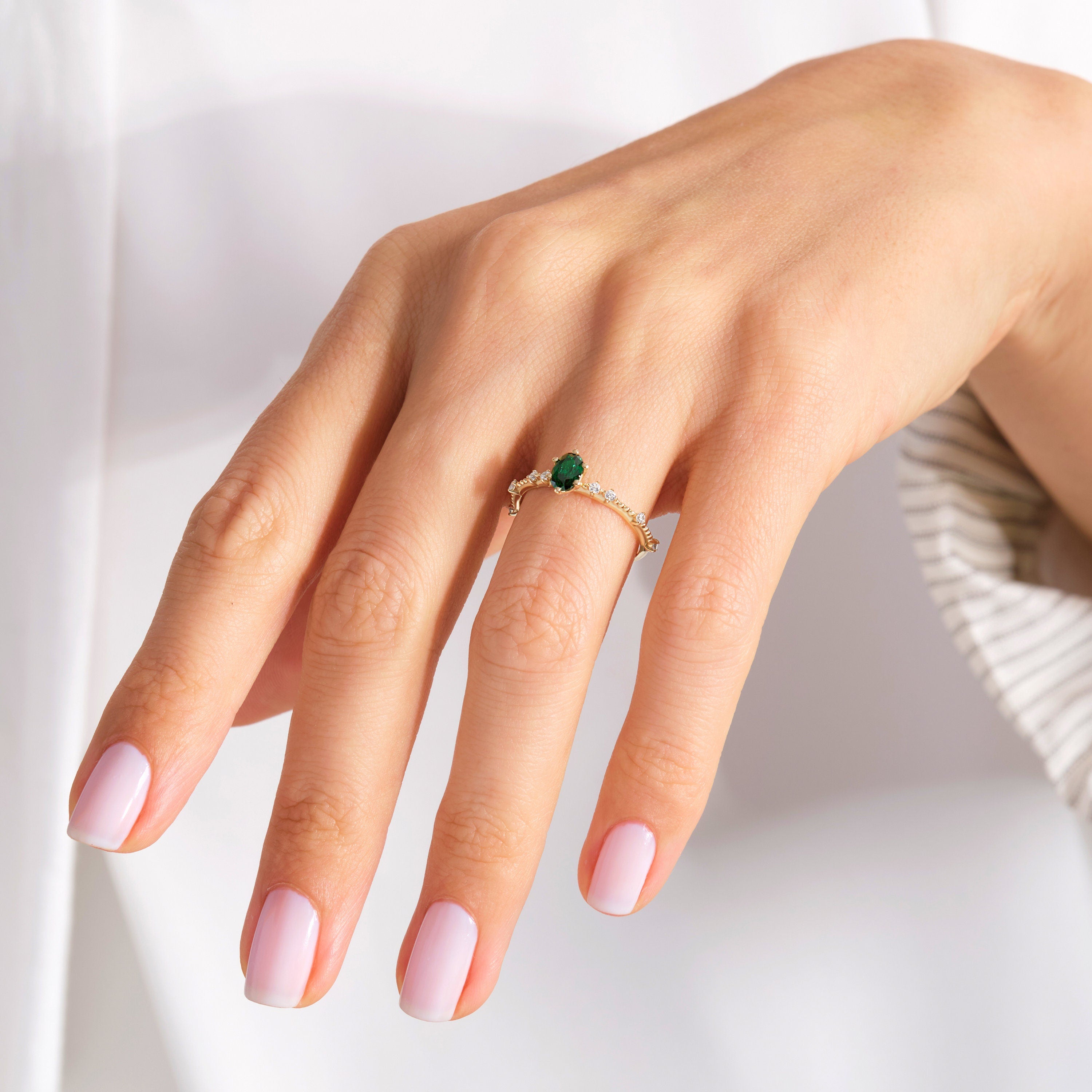 Oval Emerald Engagement Ring – 14K Solid Gold with Side Diamonds 💚✨
Elegant, timeless, and deeply symbolic — this oval emerald engagement ring celebrates love and renewal in every detail. Featuring a vivid green oval-cut emerald at its center, delicately framed by a fine row of tiny moissanite diamonds, this piece perfectly balances luxury and sentiment. Its milgrain side detailing adds a subtle vintage touch, making it an ideal ring for weddings, anniversaries, or heartfelt gifts.