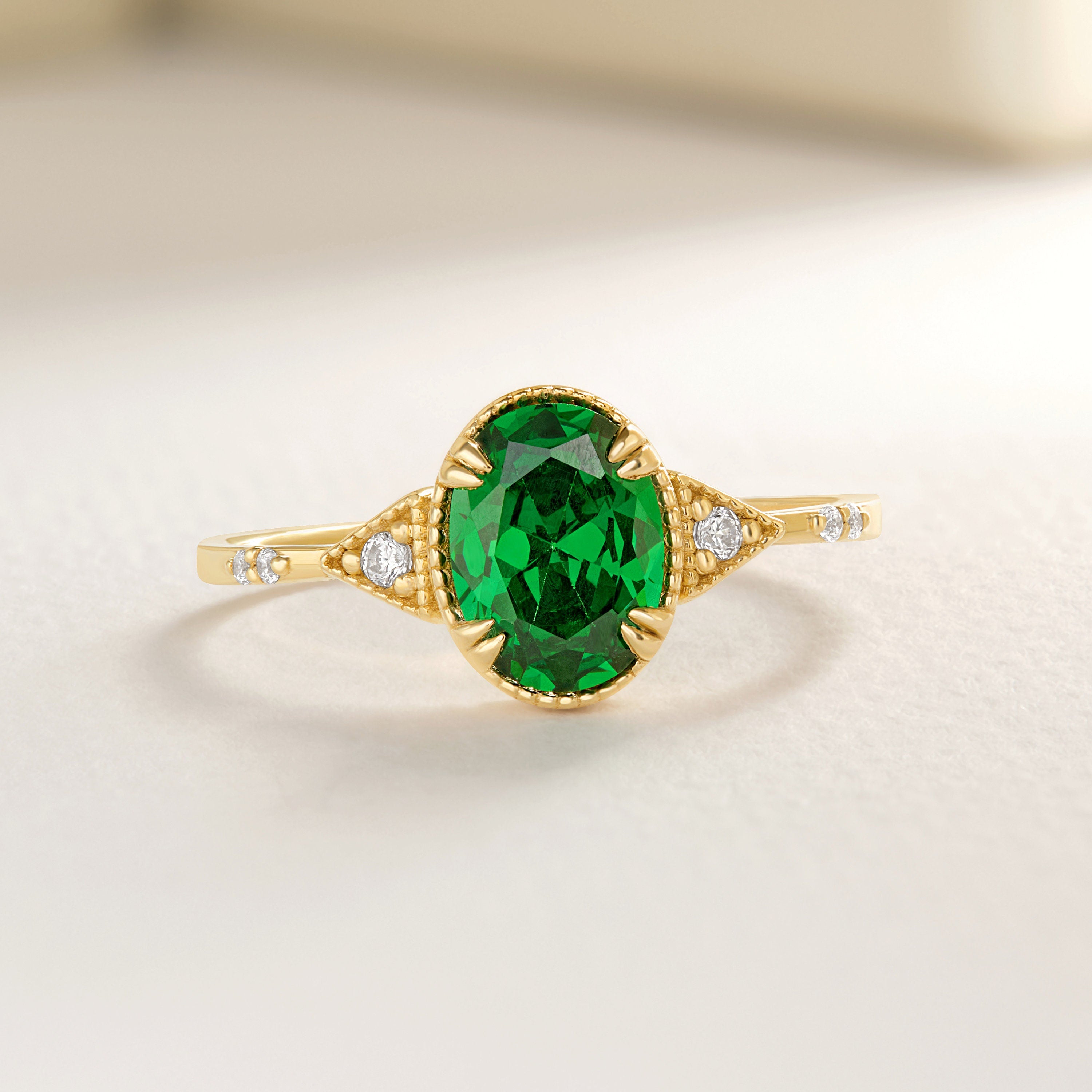 Oval Emerald Birthstone Ring – 10K / 14K / 18K Solid Gold 💚✨
A timeless oval emerald birthstone ring paired with sparkling diamonds, designed in an art deco style. This dainty and elegant piece is perfect as a promise ring, birthday gift, or a meaningful heirloom jewelry for your loved ones.