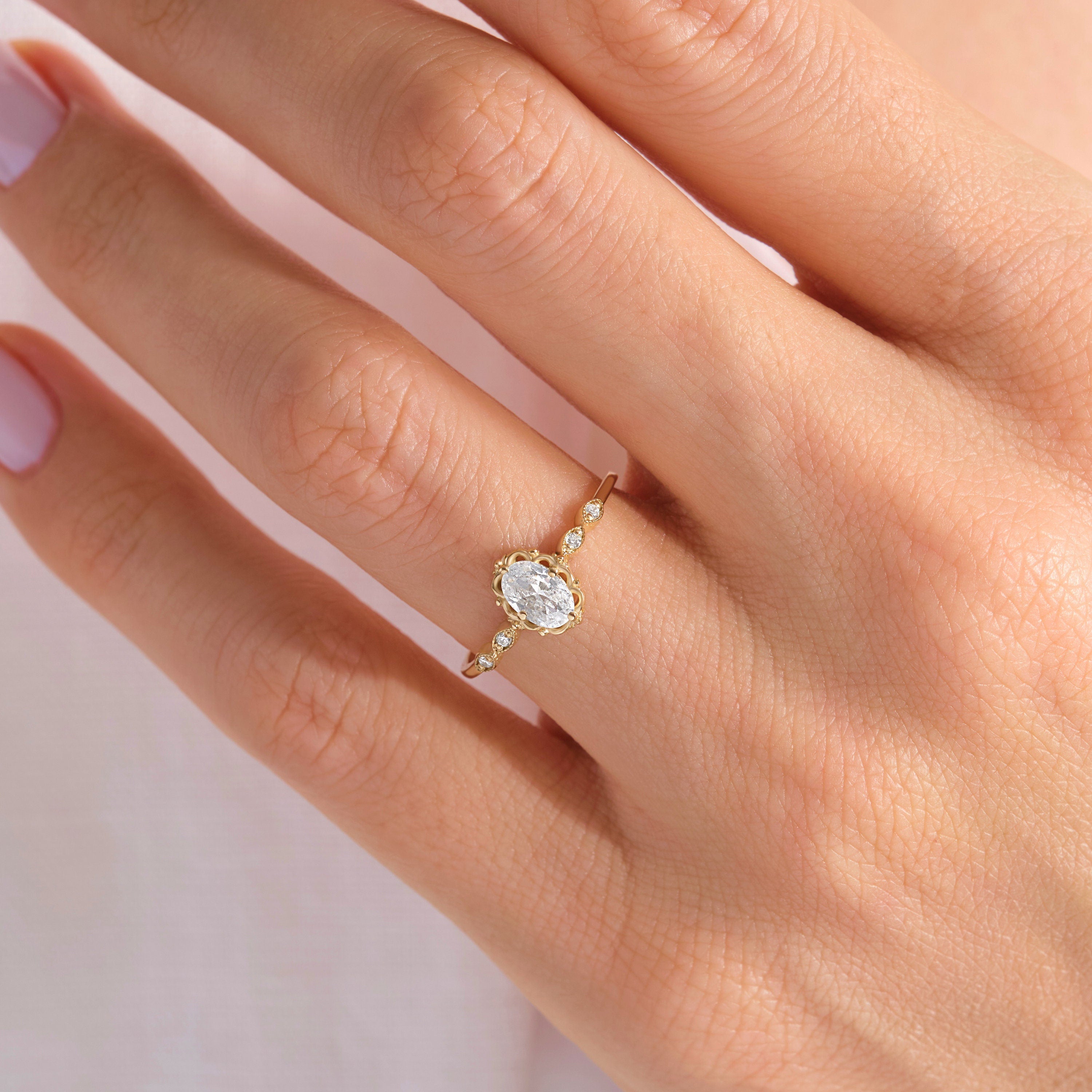 💍 Oval Diamond Engagement Ring — 14K Solid Gold Moissanite Wedding Band

This elegant oval engagement ring features a sparkling center stone paired with a delicate row of tiny accent gems. Its slim solid-gold band and refined silhouette make it perfect as a proposal ring, wedding band, promise ring, or everyday luxury piece. A timeless design for women who love delicate, feminine fine jewelry.