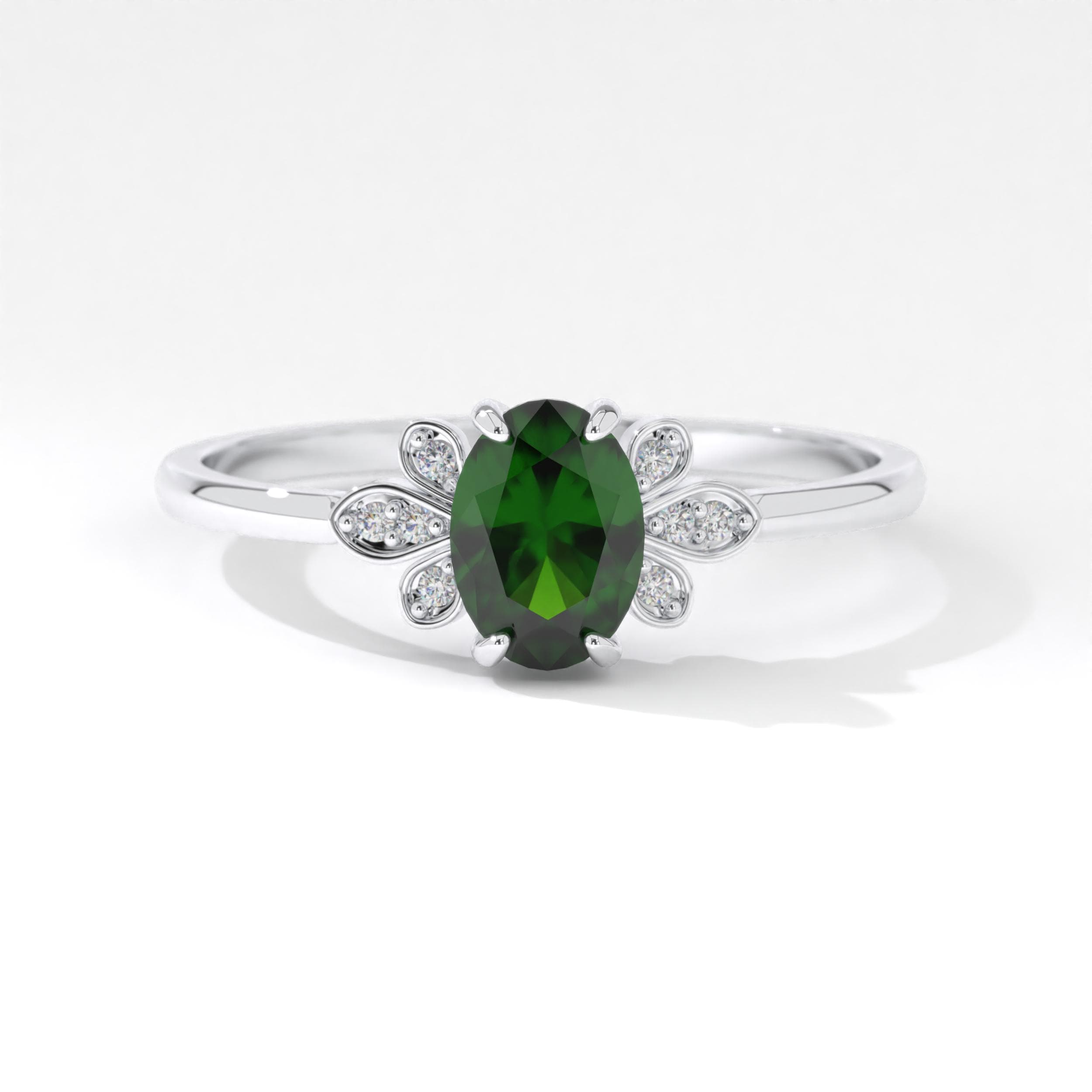 Elegant 14K white gold ring with a vibrant oval emerald stone. This design shines even brighter when customized with birthstones to create a truly personal and timeless piece