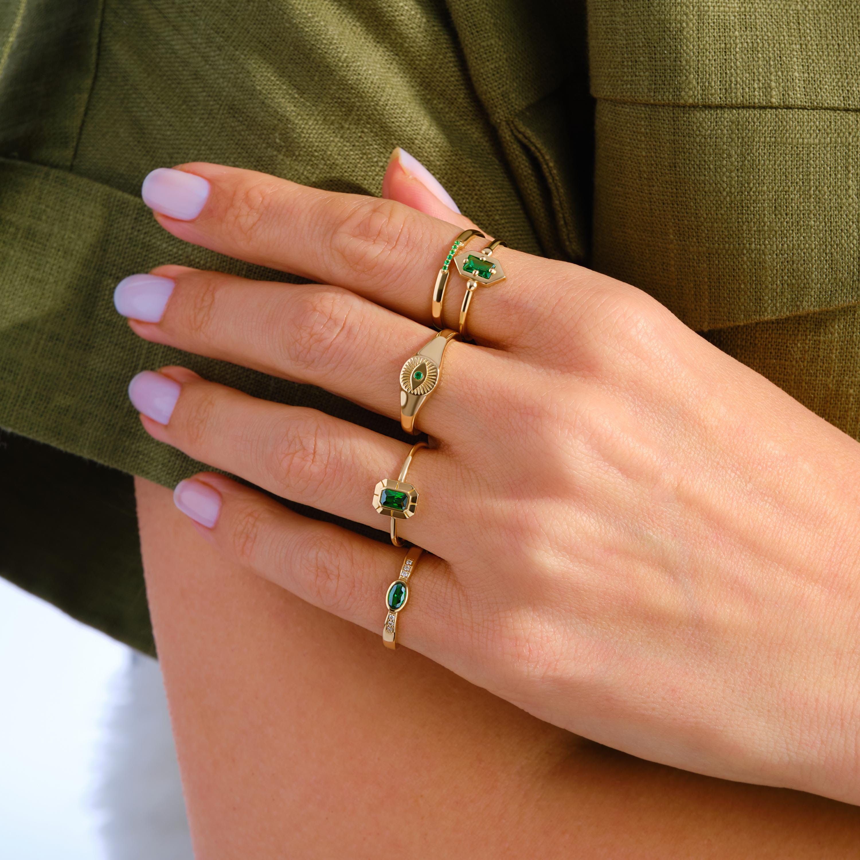 ChatGPT:

💚 Emerald Eye Signet Ring – 14K Solid Gold Bezel Set Evil Eye Dome Band 💍

Protective, elegant, and full of symbolism — this Emerald Eye Signet Ring brings a modern twist to the ancient evil eye design. Crafted from solid gold and featuring a brilliant green cubic zirconia stone, this dainty yet bold piece radiates both style and meaning. Perfect as a pinky ring, everyday statement, or symbolic gift of protection.