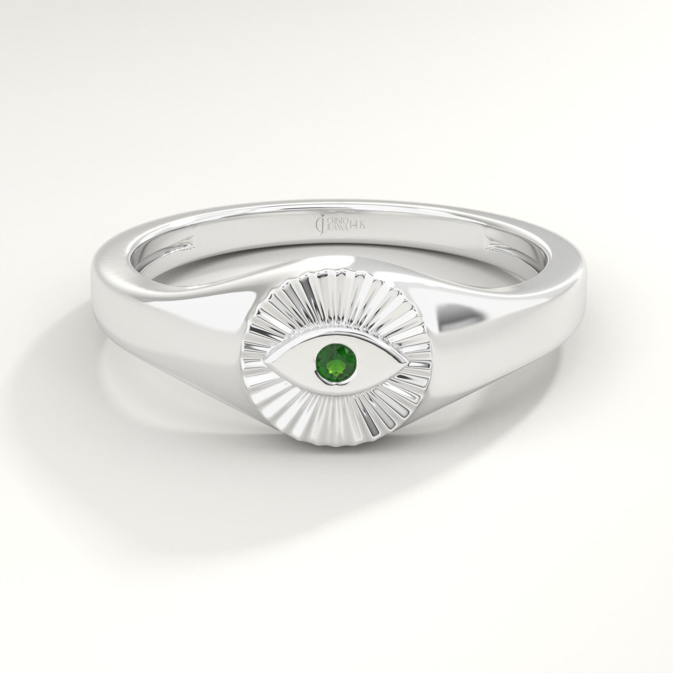 ChatGPT:

💚 Emerald Eye Signet Ring – 14K Solid Gold Bezel Set Evil Eye Dome Band 💍

Protective, elegant, and full of symbolism — this Emerald Eye Signet Ring brings a modern twist to the ancient evil eye design. Crafted from solid gold and featuring a brilliant green cubic zirconia stone, this dainty yet bold piece radiates both style and meaning. Perfect as a pinky ring, everyday statement, or symbolic gift of protection.