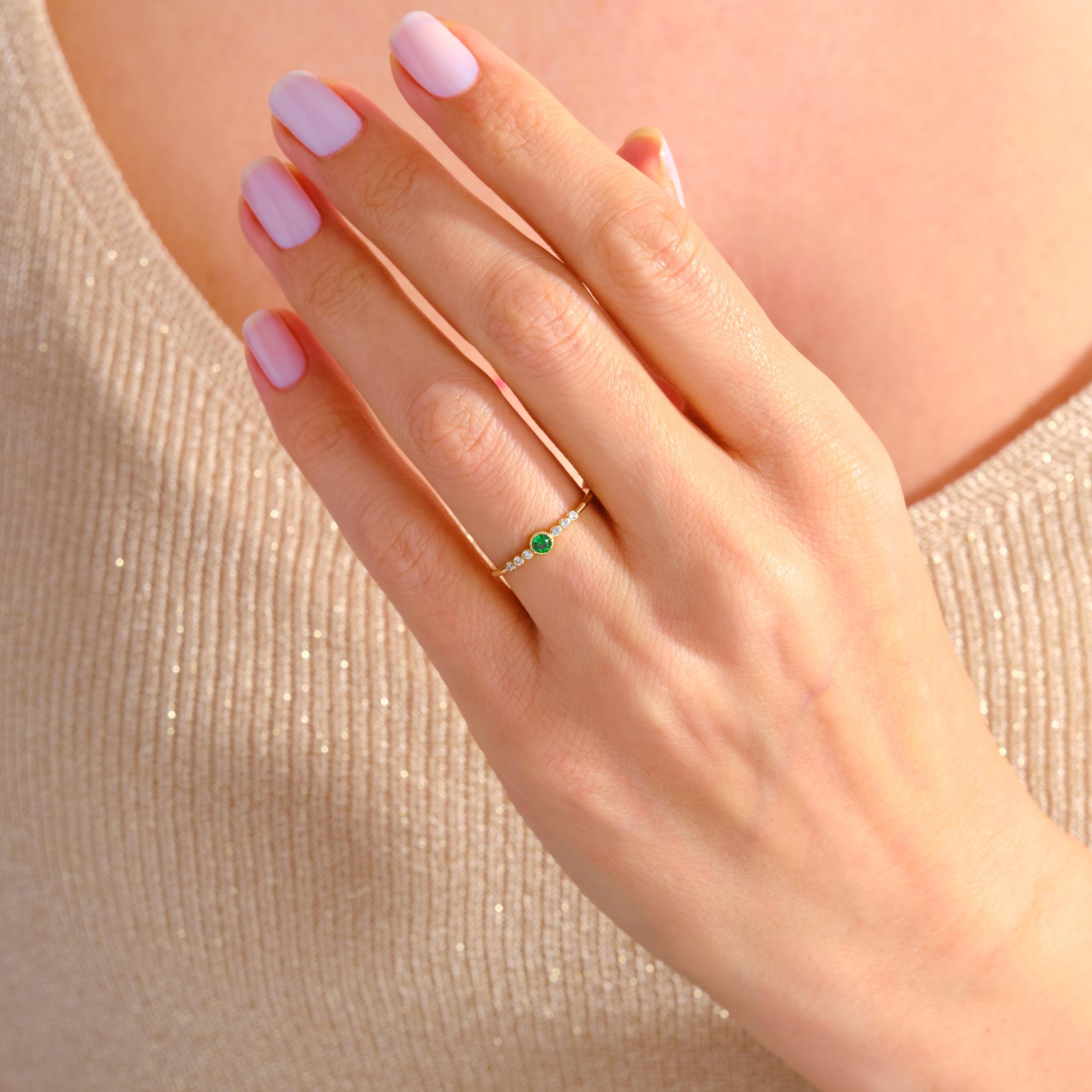 Celebrate life's milestones with this mini birthstone 14K ring — a dainty emerald ring crafted for meaningful moments. Featuring green gemstone rings and side diamond rings, it radiates timeless elegance. Perfect as an art deco gift summer piece, a promise solid gold token, or a custom birth month treasure.