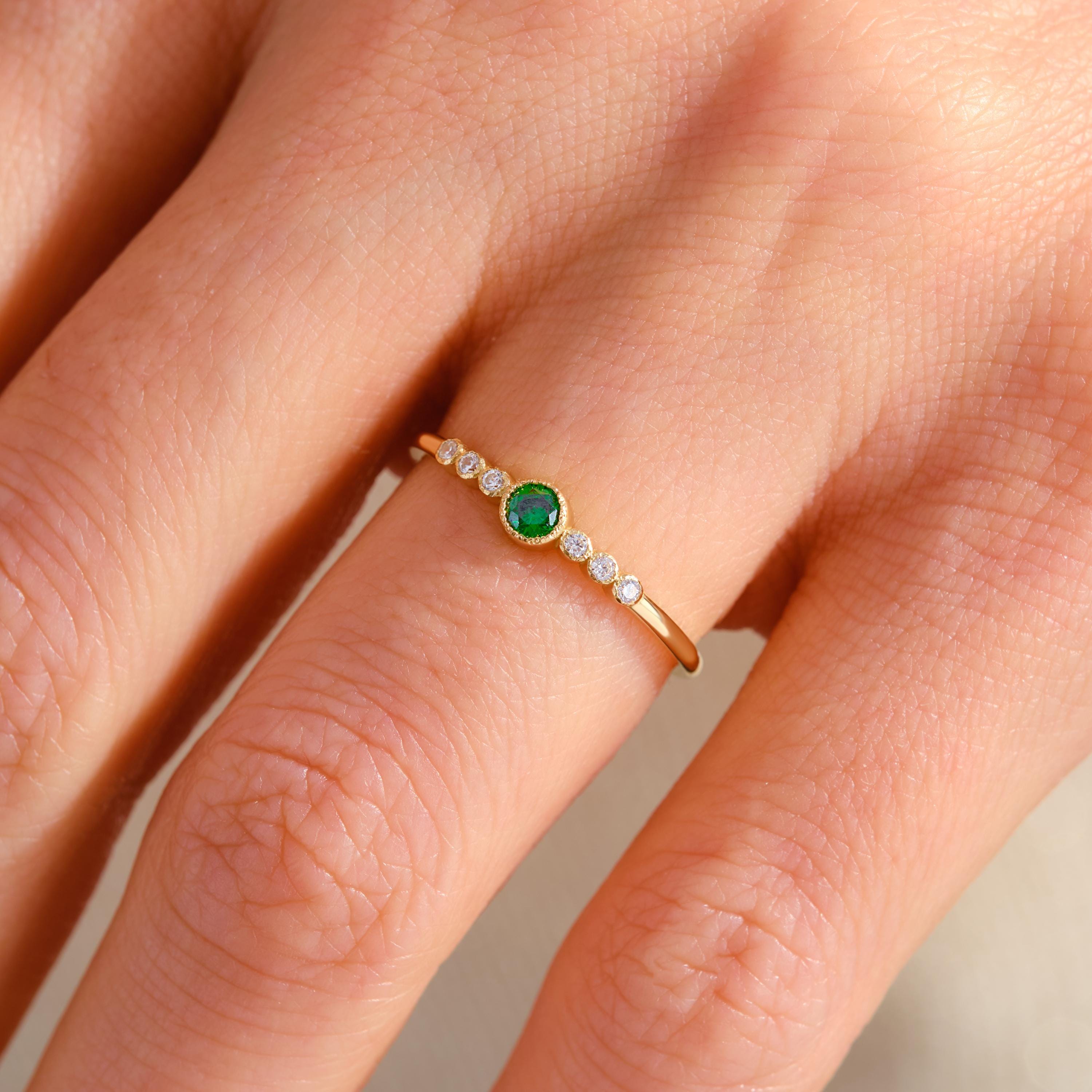 Celebrate life's milestones with this mini birthstone 14K ring — a dainty emerald ring crafted for meaningful moments. Featuring green gemstone rings and side diamond rings, it radiates timeless elegance. Perfect as an art deco gift summer piece, a promise solid gold token, or a custom birth month treasure.