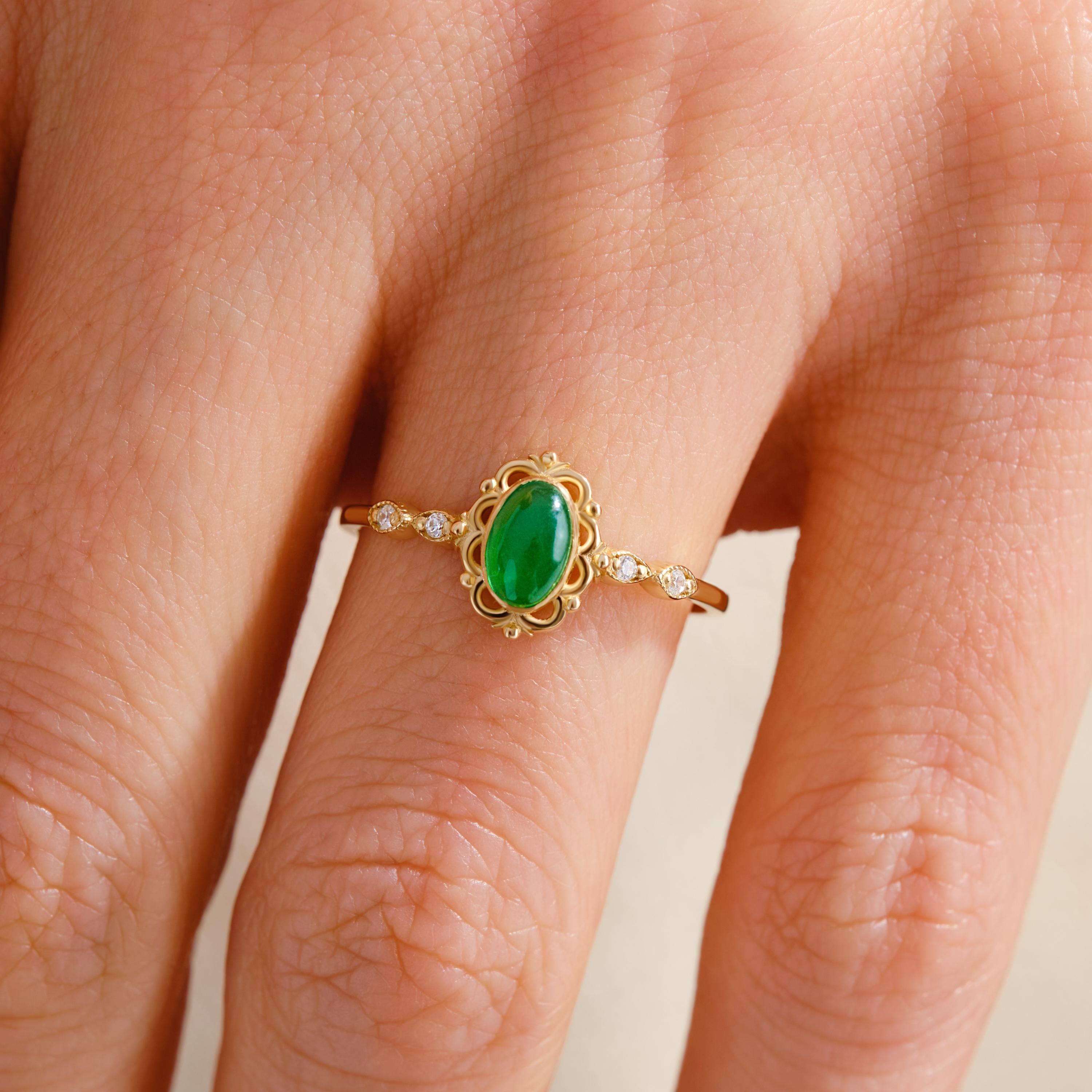 Art Deco Emerald Engagement Ring – 14K Solid Gold Filigree Wedding Band 💚✨
This stunning Art Deco Emerald Ring embodies timeless sophistication and handcrafted artistry. Featuring a vivid oval-cut emerald framed by sparkling side diamonds, the intricate filigree band showcases vintage charm with a modern twist. Perfect as a wedding, engagement, or anniversary gift, it’s a symbol of love, strength, and renewal.