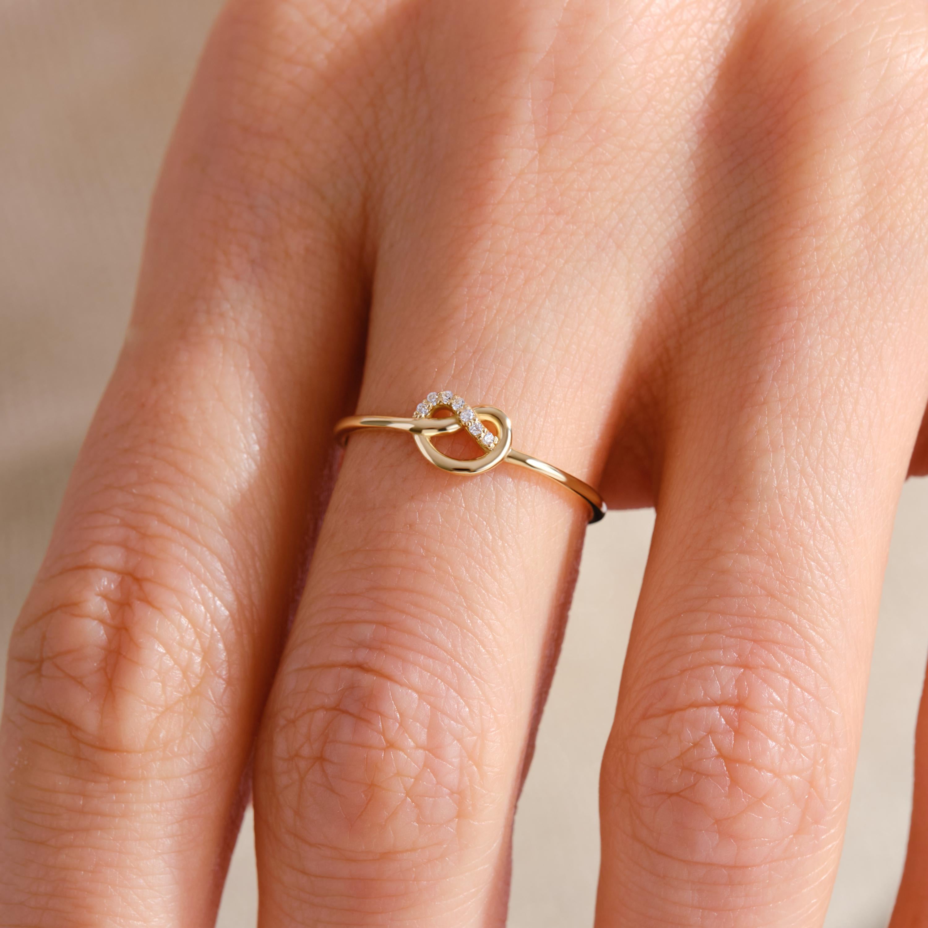 Love Knot Wedding Ring – 14K Solid Gold ✨💖
This delicate love knot ring features 7 tiny round-cut diamonds set along a dainty gold band — a timeless symbol of connection, unity, and unbreakable bonds. Perfect as a wedding promise ring, soulmate gift, or a meaningful token for your best friend.

Its minimalist heart-knot design is both elegant and symbolic, ideal for everyday wear or stacking.