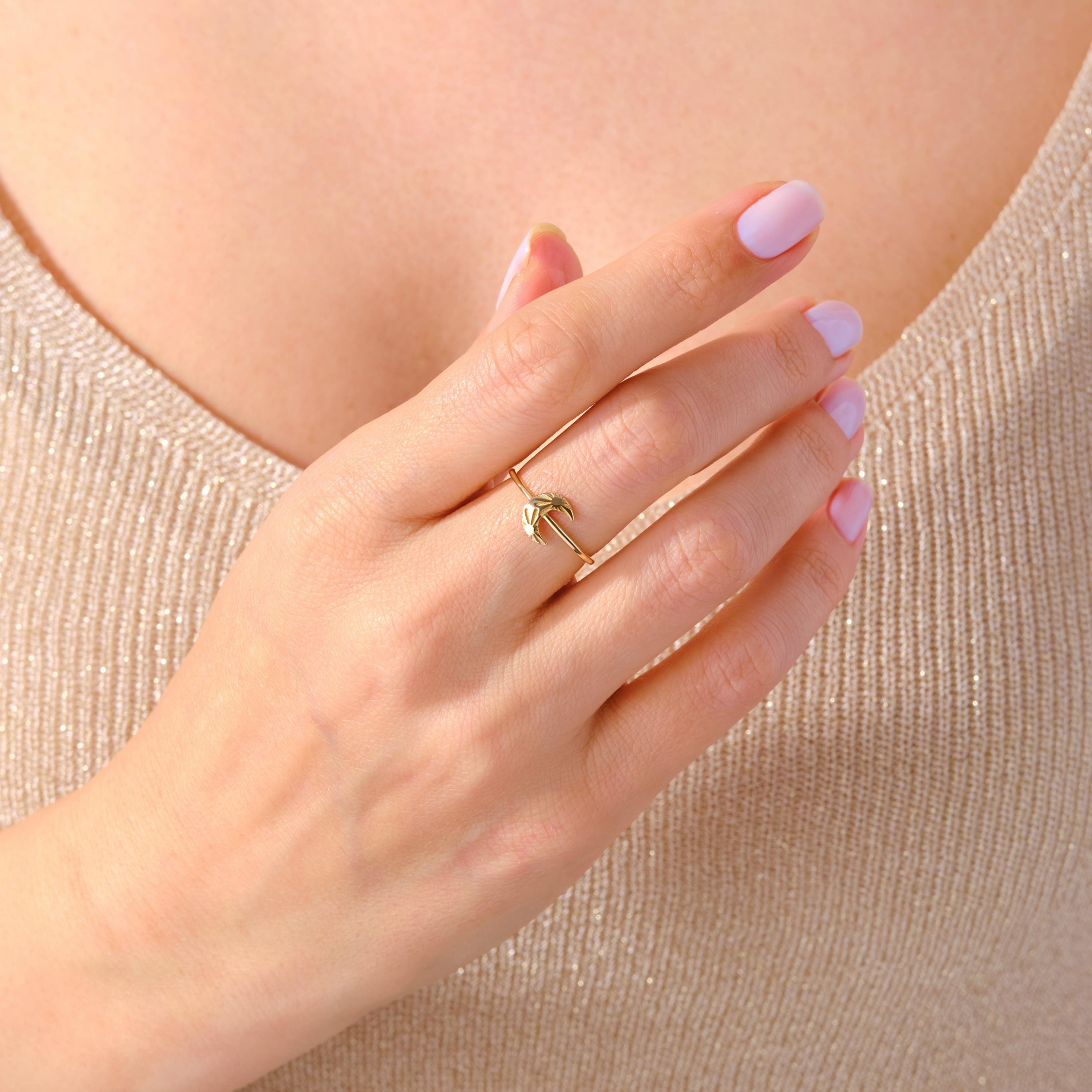 Crescent Moon Ring – 14K Solid Gold 🌙☀️
This delicate crescent moon ring features a moon and sun texture design, symbolizing balance, harmony, and the connection between day and night. Its minimalist style makes it perfect for everyday wear, stacking with other rings, or gifting to someone special who loves celestial jewelry.

The slim gold band is comfortable, timeless, and available in yellow, white, or rose gold — making it a versatile piece for any jewelry collection.