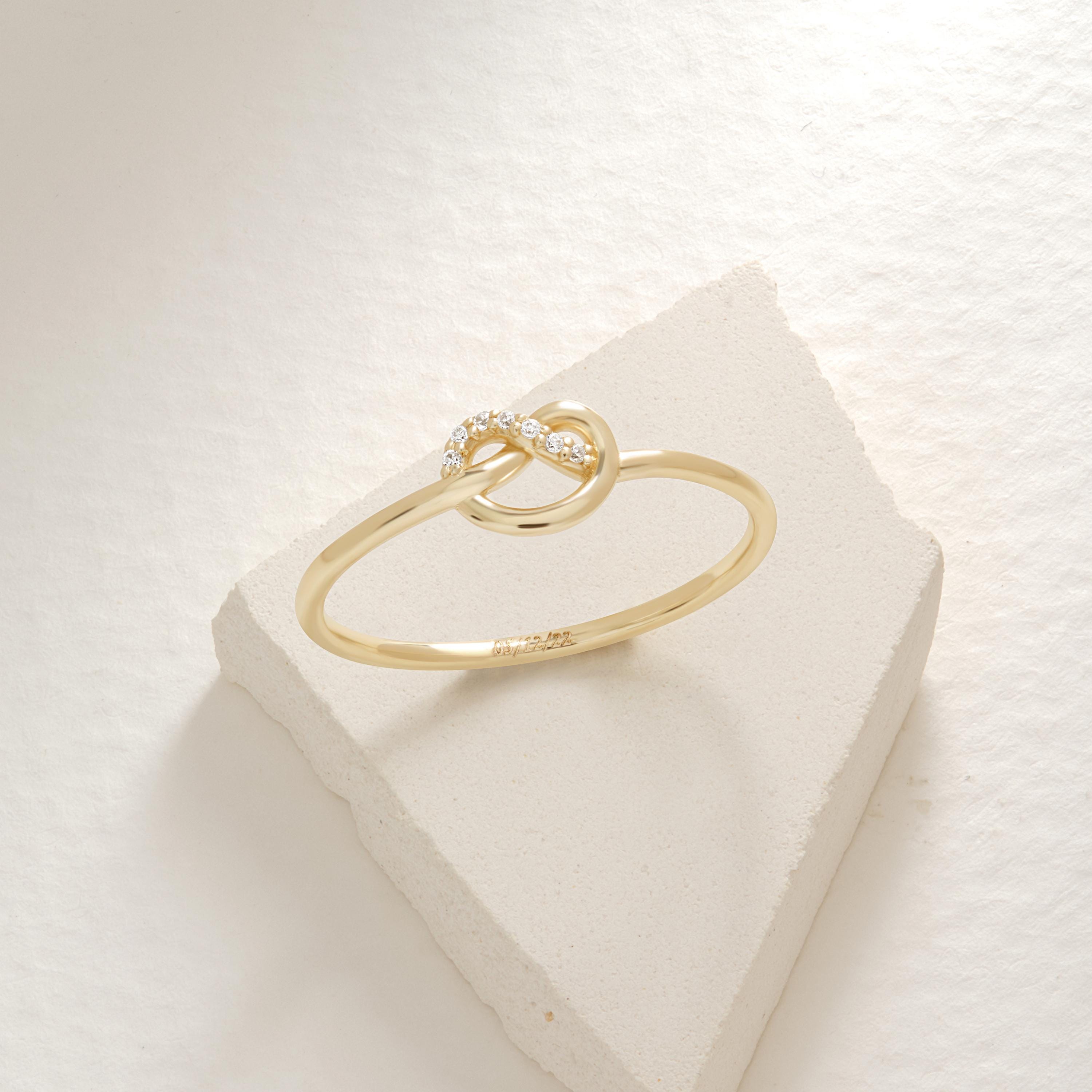 Love Knot Wedding Ring – 14K Solid Gold ✨💖
This delicate love knot ring features 7 tiny round-cut diamonds set along a dainty gold band — a timeless symbol of connection, unity, and unbreakable bonds. Perfect as a wedding promise ring, soulmate gift, or a meaningful token for your best friend.

Its minimalist heart-knot design is both elegant and symbolic, ideal for everyday wear or stacking.
