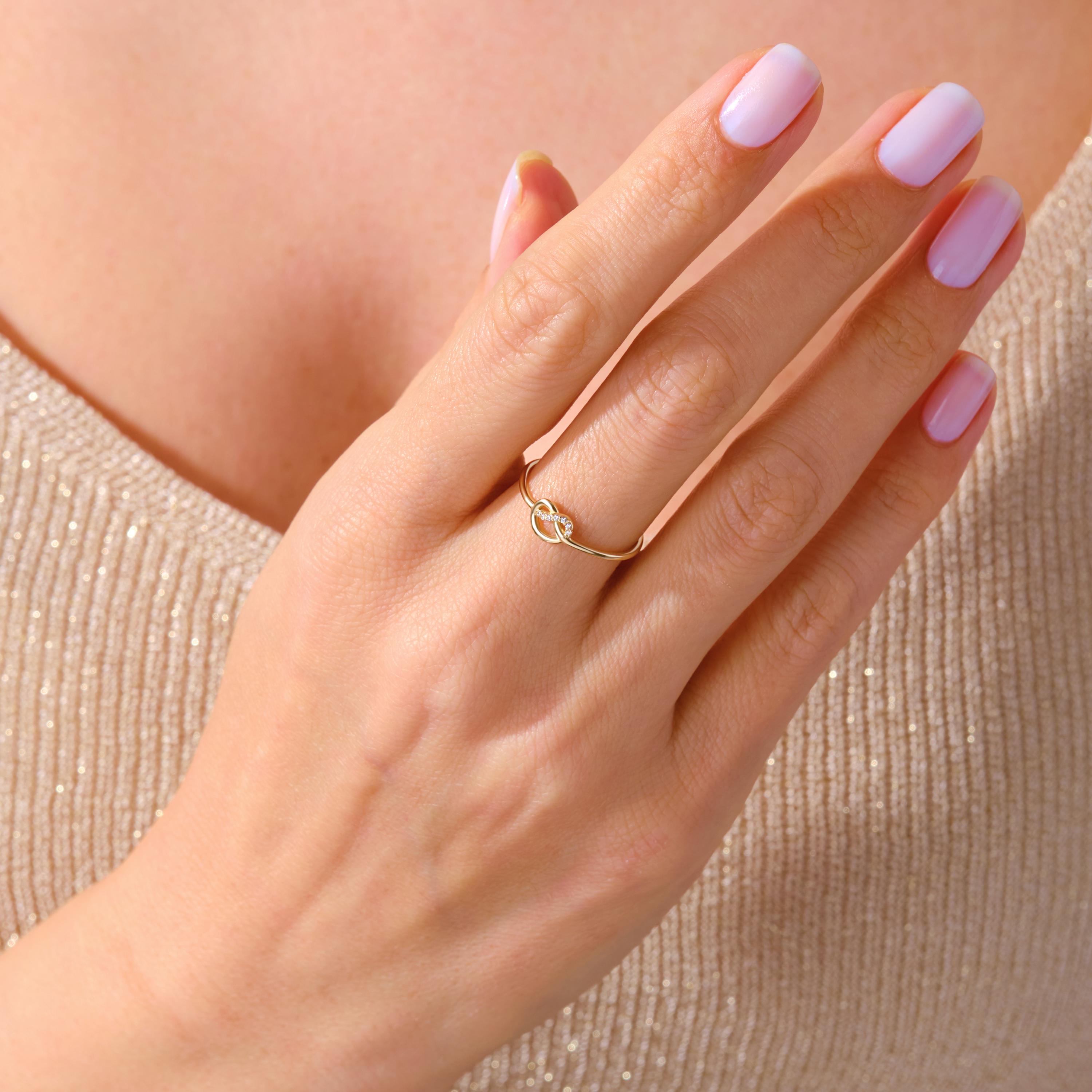 Love Knot Wedding Ring – 14K Solid Gold ✨💖
This delicate love knot ring features 7 tiny round-cut diamonds set along a dainty gold band — a timeless symbol of connection, unity, and unbreakable bonds. Perfect as a wedding promise ring, soulmate gift, or a meaningful token for your best friend.

Its minimalist heart-knot design is both elegant and symbolic, ideal for everyday wear or stacking.