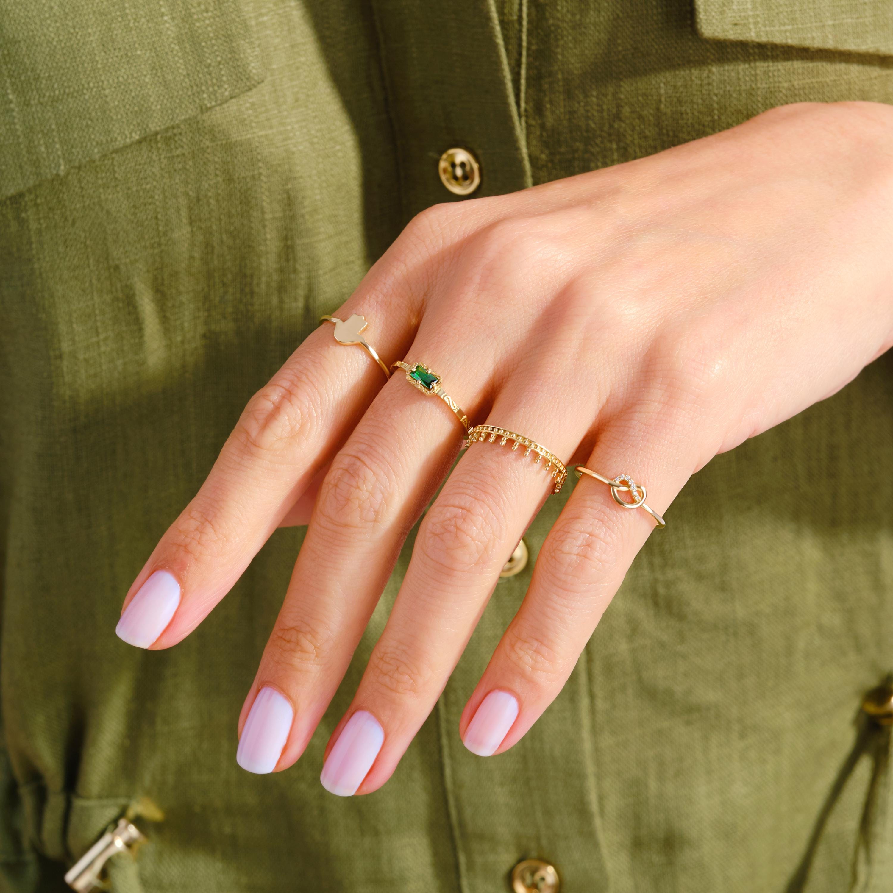Love Knot Wedding Ring – 14K Solid Gold ✨💖
This delicate love knot ring features 7 tiny round-cut diamonds set along a dainty gold band — a timeless symbol of connection, unity, and unbreakable bonds. Perfect as a wedding promise ring, soulmate gift, or a meaningful token for your best friend.

Its minimalist heart-knot design is both elegant and symbolic, ideal for everyday wear or stacking.
