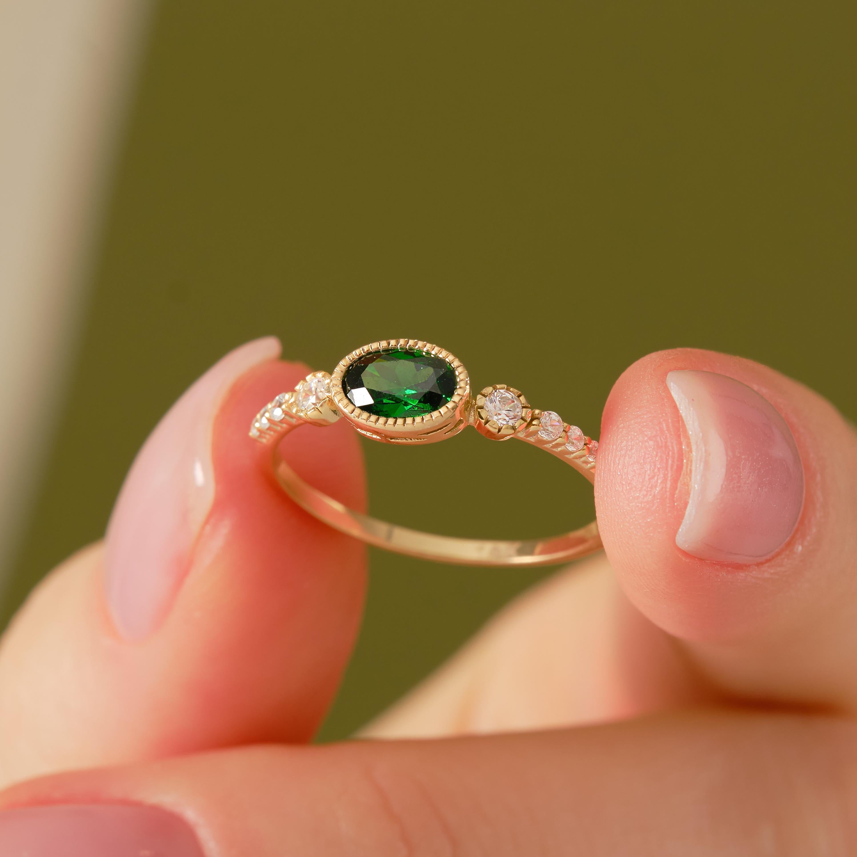 💚 Vintage Inspired Emerald Ring | Oval Birthstone Ring with Side Diamonds – 14K Solid Gold

This vintage inspired emerald ring showcases a timeless Art Deco elegance, featuring a glowing oval-cut green gemstone framed in a sleek bezel setting and accented with sparkling side stones. Handcrafted in solid gold, this ring blends classic charm with modern craftsmanship—perfect for meaningful moments and everyday luxury.