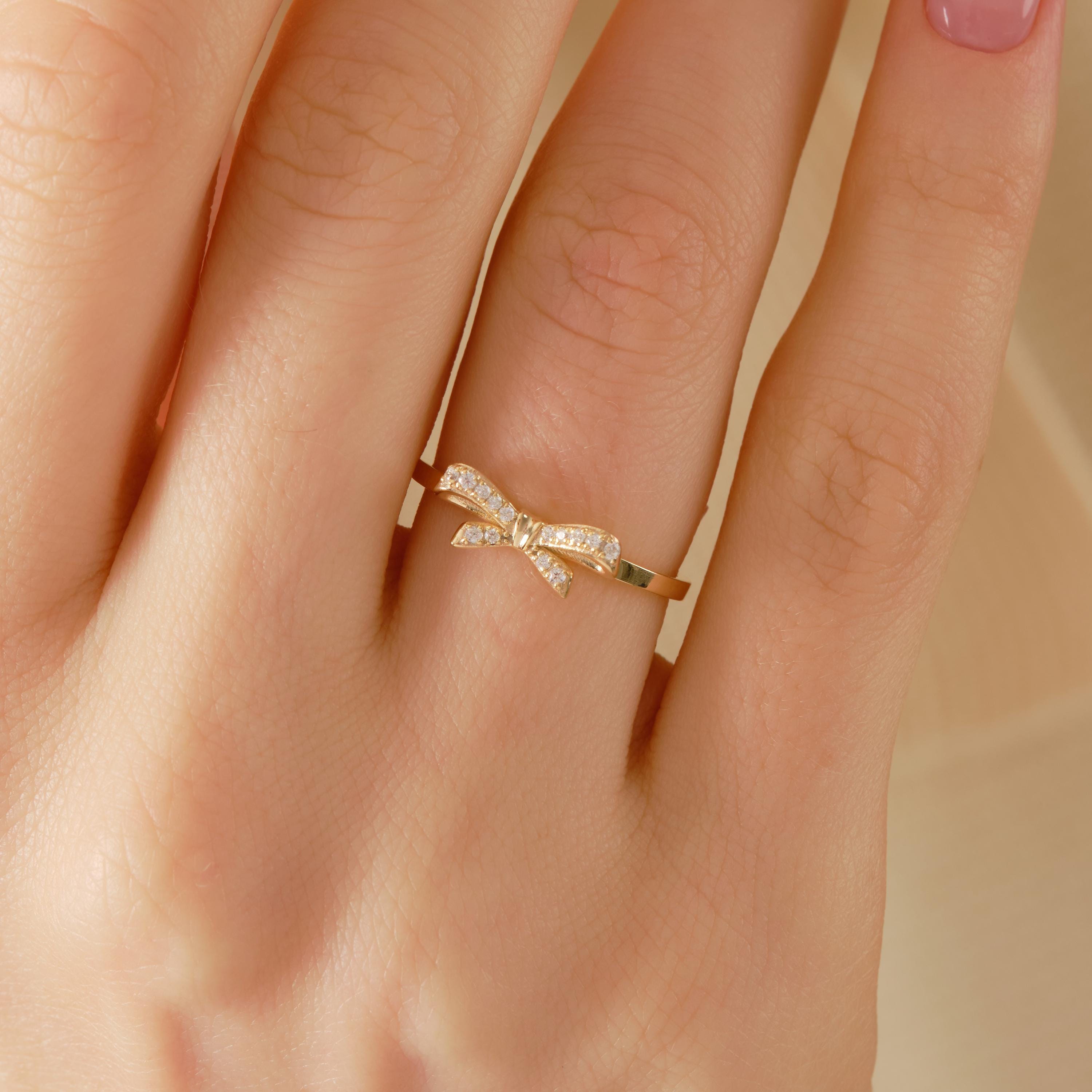 ✨ 14K Solid Gold Ribbon Ring – Dainty Diamond Bowtie Ring for Women
Little Bowknot Ring • Symbol of Love, Friendship & Soulmates

Graceful, feminine, and full of meaning 🤍 This dainty ribbon bowtie ring is designed to symbolize unbreakable bonds—perfect for soulmates, best friends, or a heartfelt gift for someone special. Its elegant bow shape and delicate sparkle make it ideal for everyday wear.
